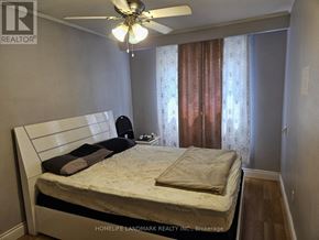 Toronto (Rouge) apartment for rent - A bedroom with a bed, pillows, and a ceiling fan.