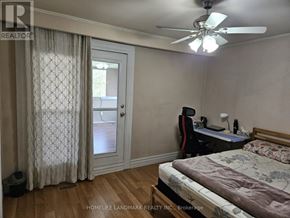 Toronto (Rouge) apartment for rent - A bedroom with a bed, desk, and window.