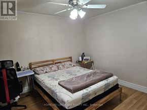 Toronto (Rouge) apartment for rent - A bedroom with a bed, desk, and chair.
