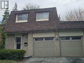 Toronto (Rouge) apartment for rent - A two-car garage with the number 102 on the door.