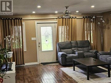 Toronto (Rouge) apartment for rent - A living room with a grey sofa and a wooden coffee table.