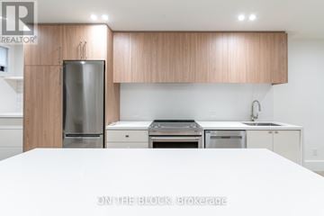 Toronto (Little Portugal) apartment for rent - A modern kitchen with wooden cabinets and stainless steel appliances.