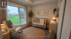 St. Catharines (E. Chester) townhouse for rent - A baby's room with a crib, chair, and pictures on the wall.
