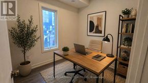 St. Catharines (E. Chester) townhouse for rent - A room with a desk, chair, and a plant.