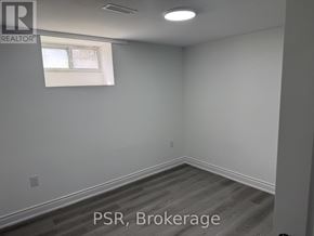 Toronto (Parkwoods-Donalda) apartment for rent - A spacious kitchen with white cabinets and a marble countertop.