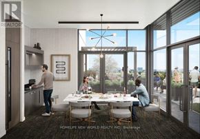 Hamilton (Kirkendall) condo for rent - A modern kitchen with people dining in the background.