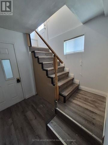 Barrie (South Shore) apartment for rent - A staircase with a wooden handrail and steps leading up to a window.