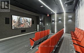 Toronto (Waterfront Communities) condo for rent - A movie theater with red seats and a large screen.
