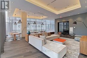 Toronto (Waterfront Communities) condo for rent - A modern living room with a white sofa and a wooden coffee table.