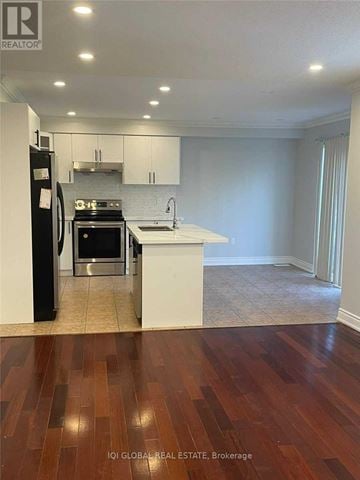 Ajax (Northwest Ajax) apartment for rent - A kitchen with white cabinets and a black refrigerator.
