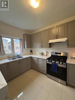 Brock (Beaverton) apartment for rent - A kitchen with a stove top oven and a sink.