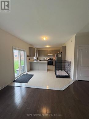 Brock (Beaverton) apartment for rent - A spacious room with a kitchen area and a dog crate.