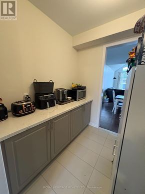 Brock (Beaverton) apartment for rent - A kitchen with grey cabinets and a white fridge.