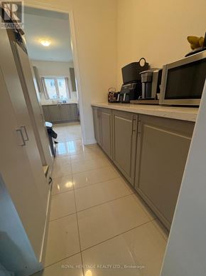 Brock (Beaverton) apartment for rent - A kitchen with a refrigerator, microwave, and cabinets.