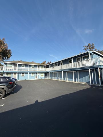 Sunnyvale apartment for rent - A blue building with a car parked in front.