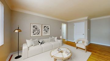 Denver apartment for rent - A living room with a white couch and a coffee table.