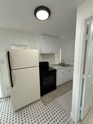 Fort Lauderdale apartment for rent - A white fridge in a kitchen with black and white tiles.