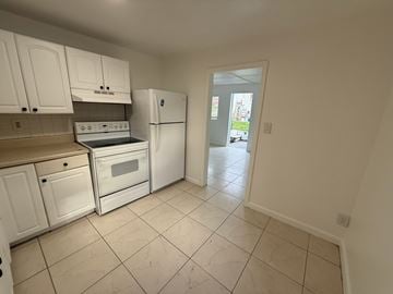 Fort Lauderdale apartment for rent - A kitchen with white cabinets and appliances.
