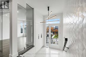 Ottawa apartment for rent - A modern interior space with a white geometric wall and a glass door leading to a balcony.