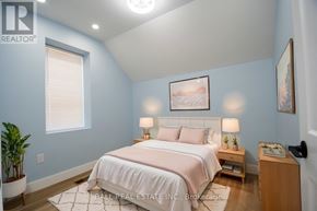 Asphodel-Norwood (Norwood) apartment for rent - A bedroom with a bed, nightstand, and lamp.