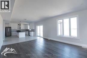 Chatham apartment for rent - A spacious, empty room with a kitchen area and a dining table.