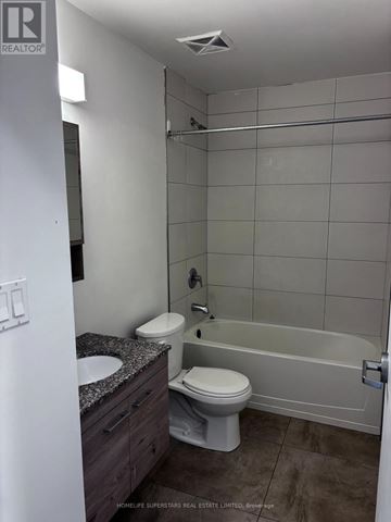 Waterloo townhouse for rent - A white bathroom with a toilet, sink, and bathtub.