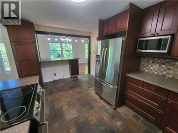 Ancaster apartment for rent - A kitchen with a stove top oven and a refrigerator.