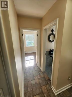 Ancaster apartment for rent - A hallway with a door on the right and a window on the other side.