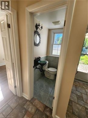 Ancaster apartment for rent - A bathroom with a toilet and a mirror.