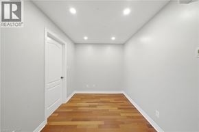Paris condo for rent - A room with wooden flooring and white walls.