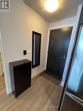 Toronto (Parkwoods-Donalda) condo for rent - A black cabinet sits in a kitchen next to a fridge.