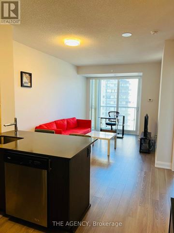 Toronto (Parkwoods-Donalda) condo for rent - A kitchen with a red couch in the living room.