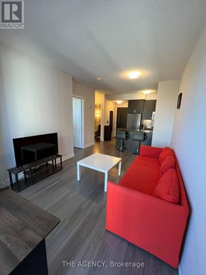 Toronto (Parkwoods-Donalda) condo for rent - A living room with a red couch and a white coffee table.