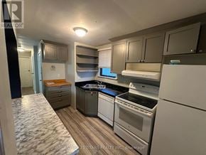 Toronto (Birchcliffe-Cliffside) apartment for rent - A kitchen with a white fridge, stove, and oven.
