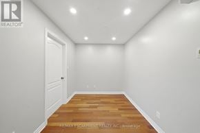 Brant (Paris) condo for rent - A room with a wooden floor and white walls.