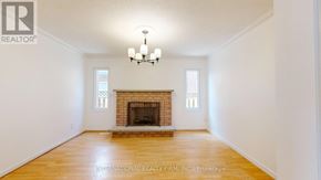 Markham (Middlefield) apartment for rent - A large, empty room with a fireplace and a chandelier.