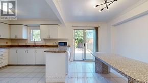 Markham (Middlefield) apartment for rent - A kitchen with white cabinets and a granite countertop.