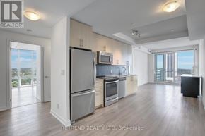 Kitchener condo for rent - A kitchen with a refrigerator, oven, and microwave.