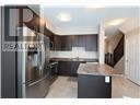 Hamilton (Carpenter) townhouse for rent - A kitchen with a refrigerator, sink and counter.
