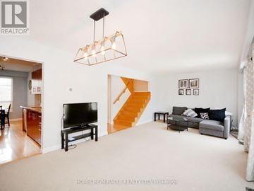 Mississauga (Erin Mills) apartment for rent - A living room with a television and a staircase.