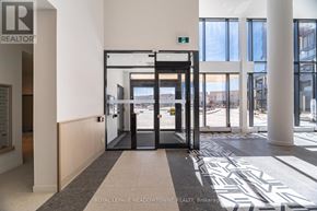 Burlington (Alton) condo for rent - A hallway with a Royal LePage logo on the wall.