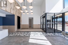 Burlington (Alton) condo for rent - A modern interior space with a patterned floor and hanging lights.