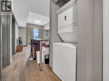 Waterloo condo for rent - A modern kitchen with a white oven and a wooden floor.