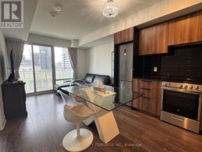 Toronto (Church-Yonge Corridor) condo for rent - A modern kitchen with a glass table and two white chairs.
