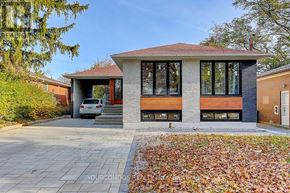 Toronto (Parkwoods-Donalda) apartment for rent - A modern house with a grey front yard and a car parked in front.