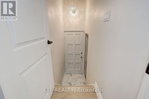 Toronto (Parkwoods-Donalda) apartment for rent - A white door in a hallway with a light on the wall.