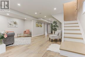 Toronto (Parkwoods-Donalda) apartment for rent - A spacious living room with a staircase leading to the upper floor.