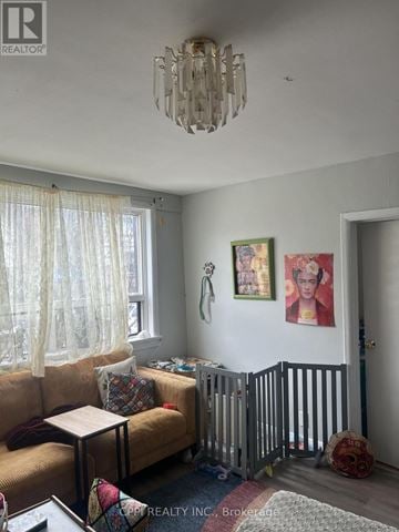 Ajax (Central West) multi-family for rent - A living room with a tan couch and a chandelier.