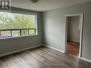 Ajax (Central West) multi-family for rent - A room with a shelf full of clothes and a clock on the wall.