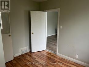 Ajax (Central West) multi-family for rent - A white refrigerator stands in a kitchen with a sink and stove.